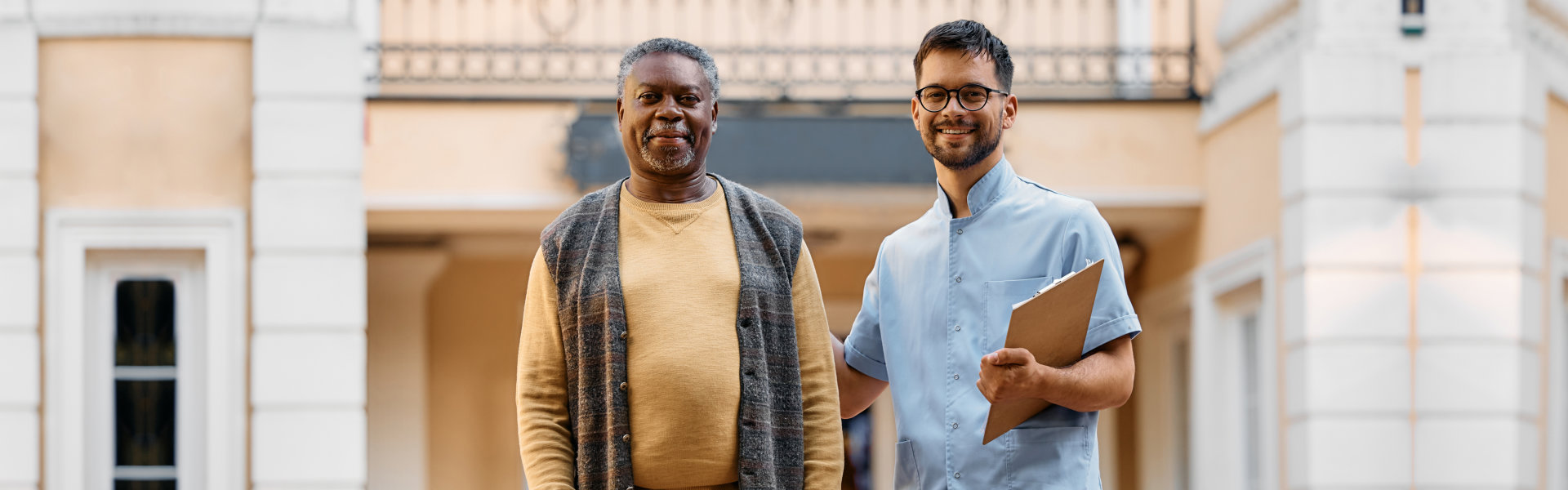 nurse holding folder with elderly man